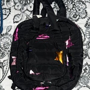 Stylish Black with colored stars. Backpack. New. No smells. The perfect smaller.